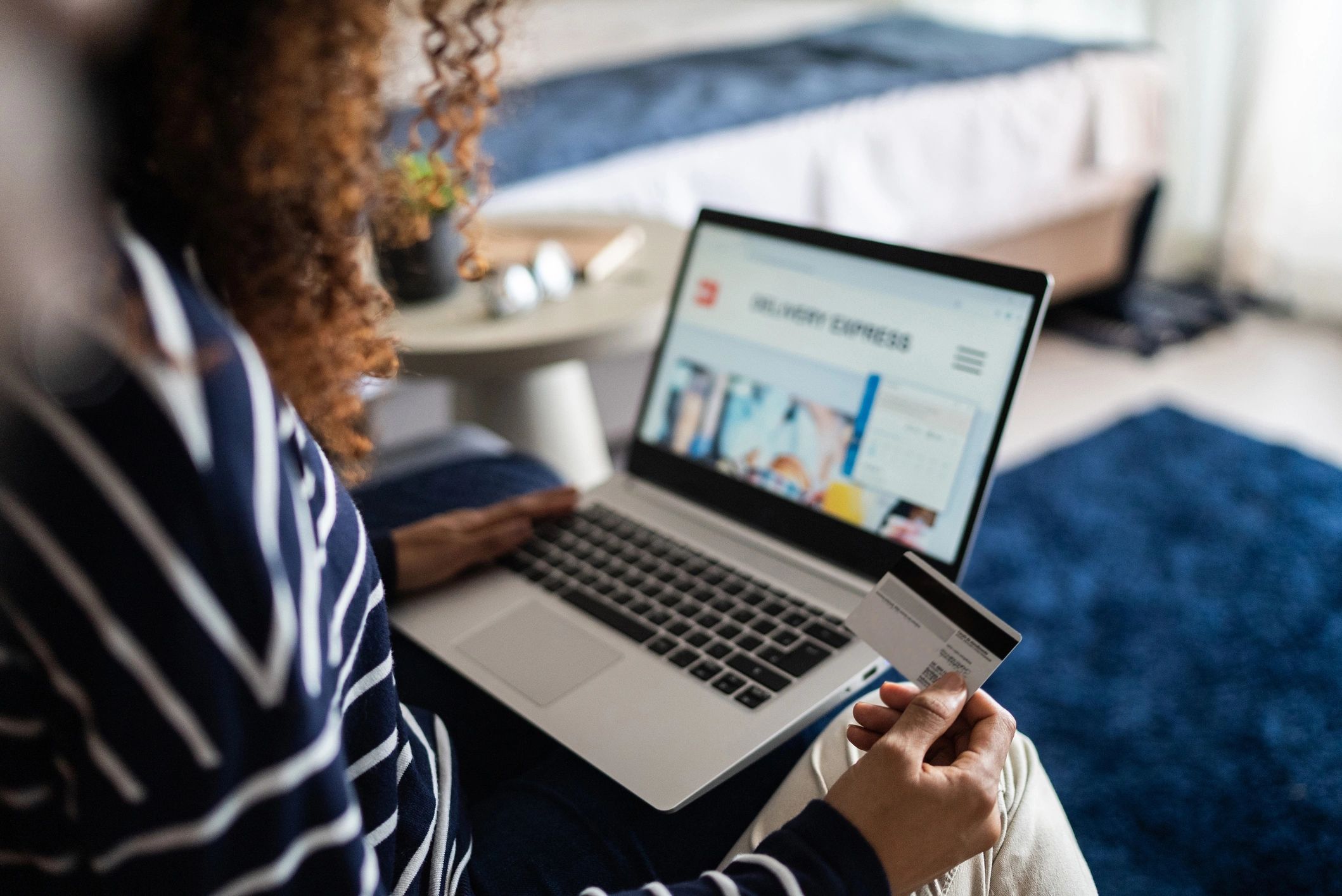 Young woman online shopping using a laptop at home