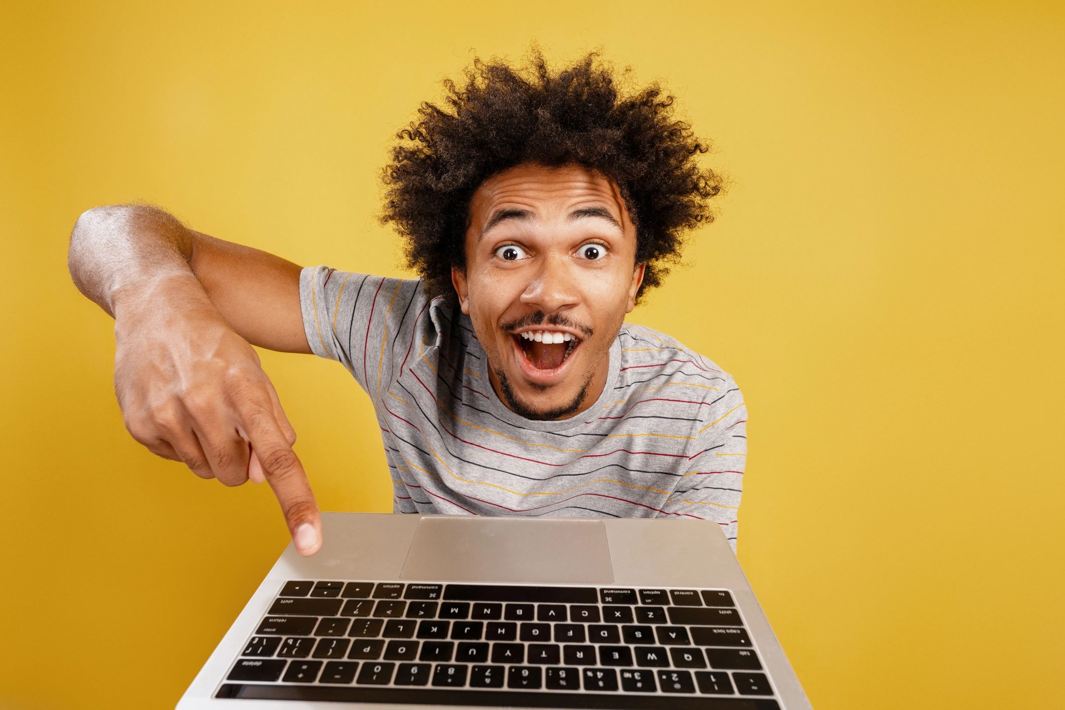 Person pointing at laptop showing a great online deal